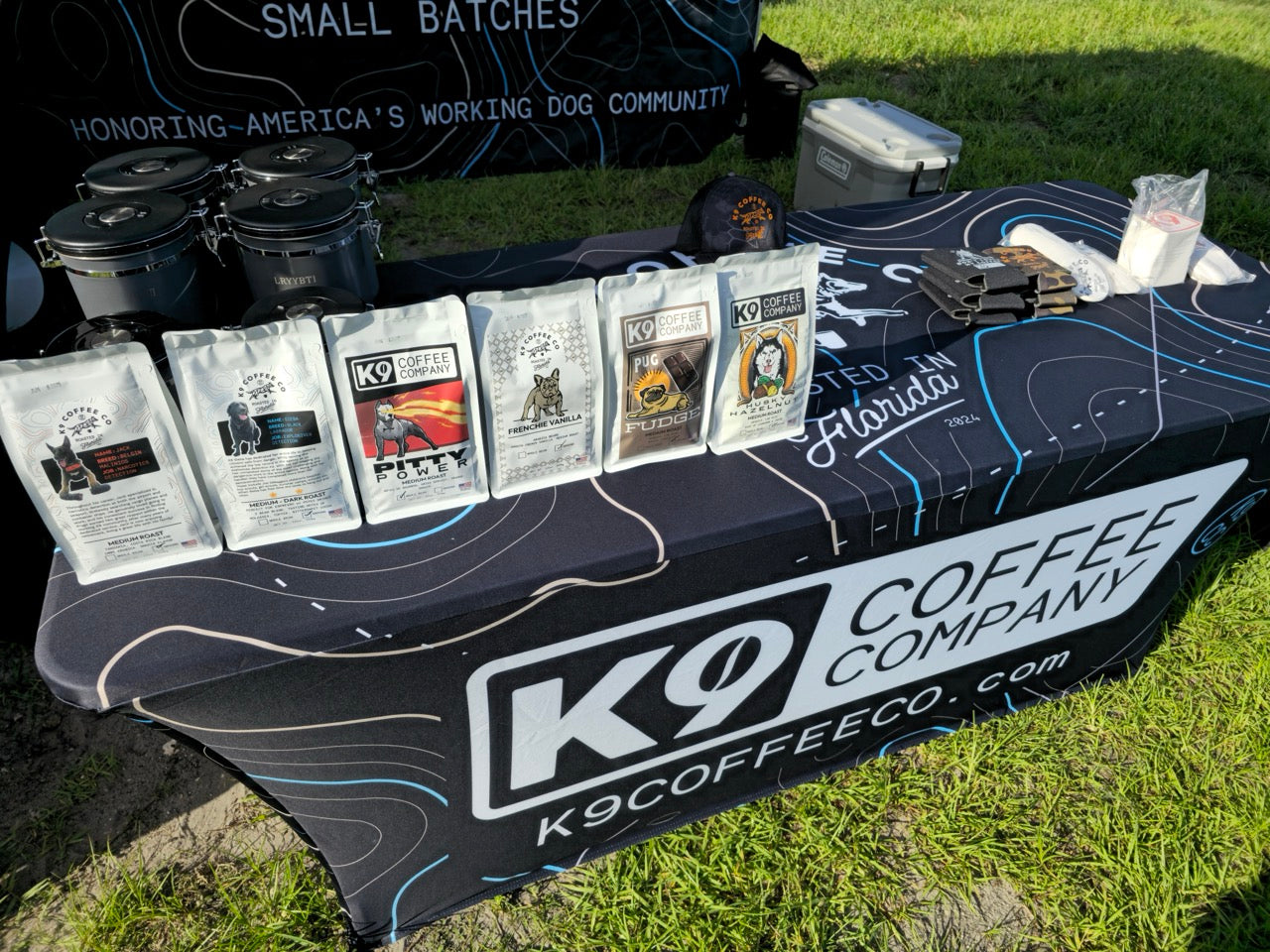 k9 coffee co at a coffee event with different types of coffee on a table