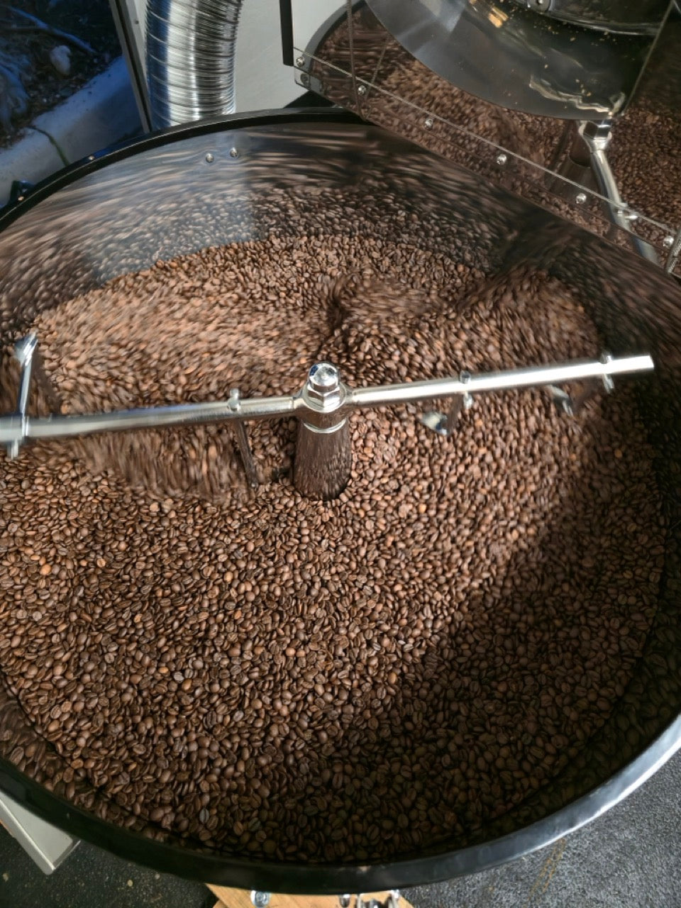 k9 coffee company, specialty fresh roasted coffee in a coffee roaster during the roasting process